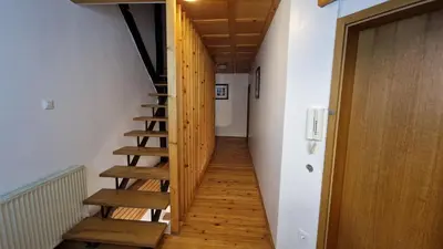 a wooden staircase in a room with a door at Ljubljana rest nest in Ljubljana