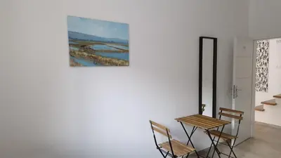 a table and chairs in a room with a painting on the wall at Ljubljana rest nest in Ljubljana