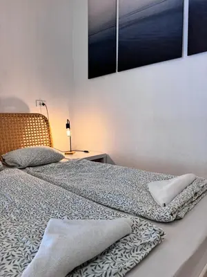 a bedroom with two beds and a table with a lamp at Ljubljana rest nest in Ljubljana