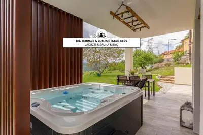 a jacuzzi tub in a house with a patio at Brkinka Apartments in Vremski Britof