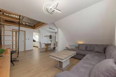 a living room with a couch and a table at Apartma pri Jakobu in Postojna