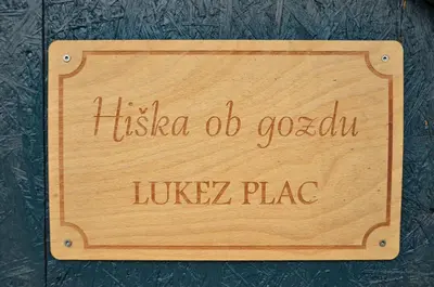 a wooden sign that reads hicea do cesar lucrezia plate at Hiška ob gozdu Lukez plac in Ljubno