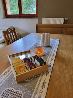 a wooden table with a box of candy on it at Rogla apartma Rdeča kapica in Vitanje