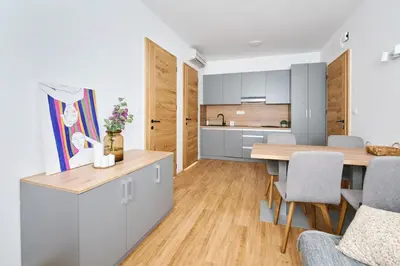 a kitchen and dining room with a table and chairs at Mozirje Comfort Apartments in Mozirje