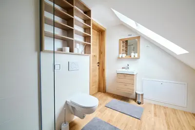 a white bathroom with a toilet and a sink at Mozirje Comfort Apartments in Mozirje