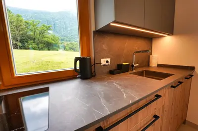 a kitchen counter with a sink and a window at House Elipsa in Bovec