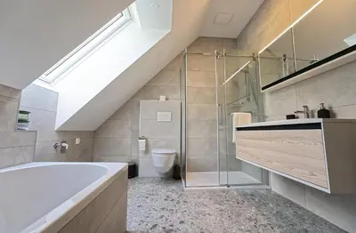 a bathroom with a bath tub and a toilet at House Elipsa in Bovec