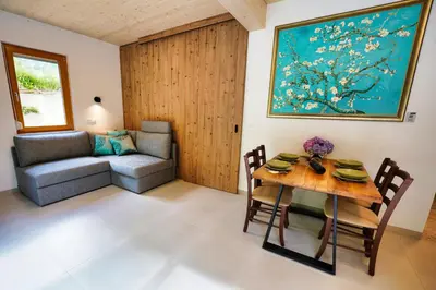 a living room with a table and a couch at House Elipsa in Bovec
