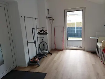 an empty room with two exercise bikes in a room with a window at Apartment house Petra in Cerklje na Gorenjskem