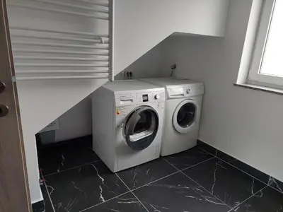 a washing machine and a washer in a room at Apartment house Petra in Cerklje na Gorenjskem