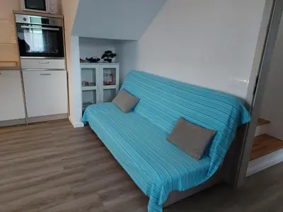a room with a bed with a blue blanket at Apartment house Petra in Cerklje na Gorenjskem