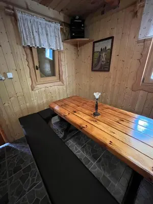 a wooden table in a room in a cabin at Cottage Žirovnica in Žirovnica