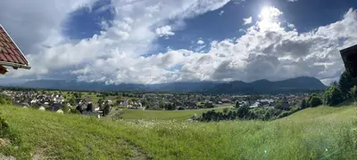 a view of a town from a grassy hill at Cottage Žirovnica in Žirovnica