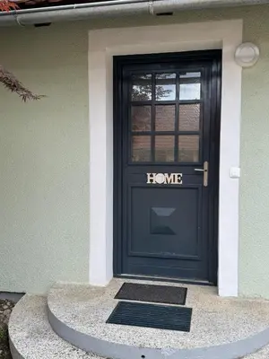 a black door with a home sign on it at Hiška HOME- TERME ČATEŽ - VKLJUČENE KOPALNE KARTE in Čatež ob Savi