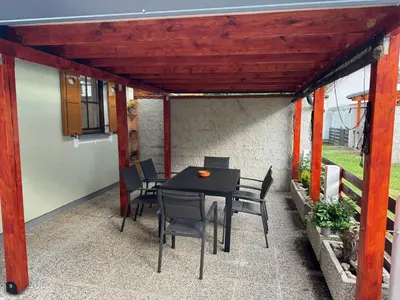a patio with a table and chairs under awning at Hiška HOME- TERME ČATEŽ - VKLJUČENE KOPALNE KARTE in Čatež ob Savi