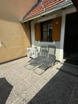two chairs sitting on a patio outside of a house at Hiška HOME- TERME ČATEŽ - VKLJUČENE KOPALNE KARTE in Čatež ob Savi