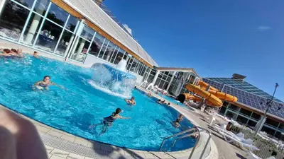 a group of people in a swimming pool on a cruise ship at Hiška HOME- TERME ČATEŽ - VKLJUČENE KOPALNE KARTE in Čatež ob Savi
