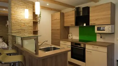 a kitchen with a sink and a microwave at Hiša Lunna - Apartments in a Forest Paradise in Vitanje