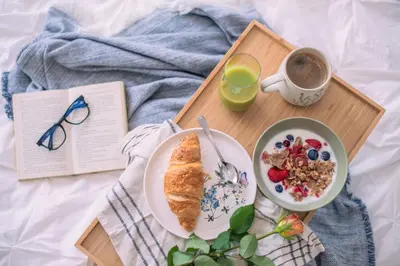 a breakfast tray with a plate of food and a cup of coffee at Apartma Zeleni Biser in Bovec