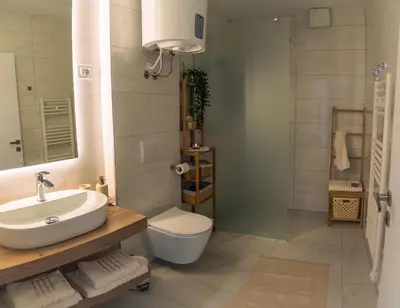 a bathroom with a sink and a toilet and a shower at Apartma Zeleni Biser in Bovec