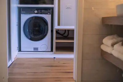 a washer and dryer sitting inside of a closet at Apartma Zeleni Biser in Bovec