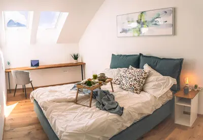 a bed in a room with a table on it at Apartma Zeleni Biser in Bovec