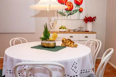 a white dining room table with a christmas tree on it at Relax apartma Peter in Ptuj