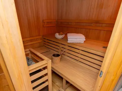 an empty sauna with two towels and a bucket at Relax apartma Peter in Ptuj