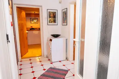 a hallway with a door leading into a room with a tile floor at Relax apartma Peter in Ptuj