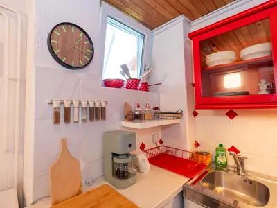 a kitchen with a sink and a clock on the wall at Relax apartma Peter in Ptuj