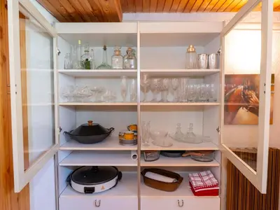 a cupboard filled with lots of glass items at Relax apartma Peter in Ptuj