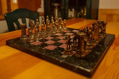 a chess board on top of a wooden table at Relax apartma Peter in Ptuj