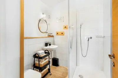 a bathroom with a shower and a toilet and a sink at Zelkonn House in Branik