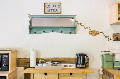 a kitchen with a table with a coffee maker on it at Zelkonn House in Branik