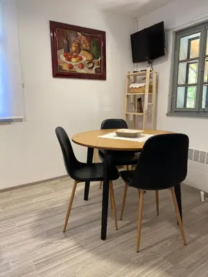 a dining room table and chairs in a room at Goričko view house in Križevci