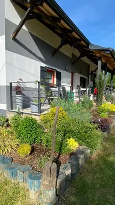 a garden in front of a house with a statue at Goričko view house in Križevci