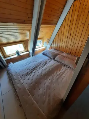 an overhead view of a bed in a wooden room at Cottage of peace, Ljubljana area in Rakitna