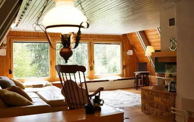 a living room with a couch and a chair at Cottage of peace, Ljubljana area in Rakitna