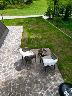 a patio with two chairs and a fire pit at Cottage of peace, Ljubljana area in Rakitna