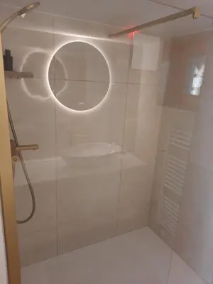 a bathroom with a shower with a mirror and a sink at Cottage of peace, Ljubljana area in Rakitna
