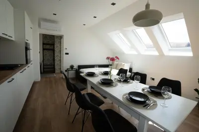 a kitchen and dining room with a table and chairs at Residence Black&White in Ljubljana