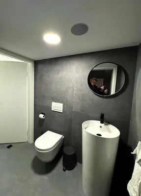 a bathroom with a toilet and a sink and a mirror at Arnold's Nest in Kotlje