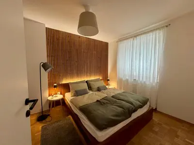 a bedroom with a large bed and a window at Arnold's Nest in Kotlje