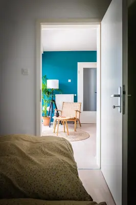 a bedroom with a door open to a living room at Arnold's Nest in Kotlje
