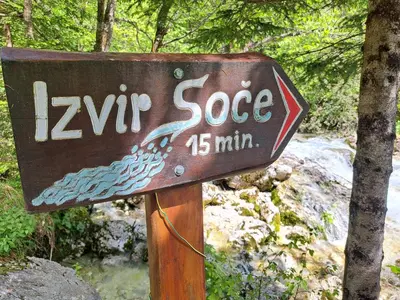 a sign that says ziripp slope in front of a waterfall at Holiday home by the emerald river in Soča