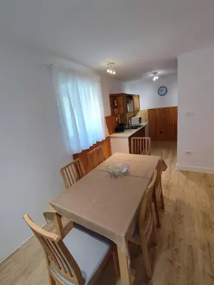 a kitchen and dining room with a table and chairs at Apartma Mirko in Bovec