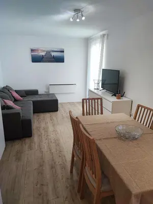 a living room with a table and a couch at Apartma Mirko in Bovec