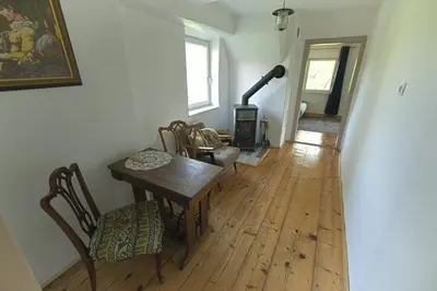 a dining room with a table and a wood stove at Vila Zora in Dobrna