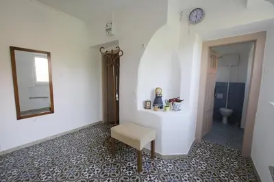 a bathroom with a chair and a mirror and a toilet at Vila Zora in Dobrna