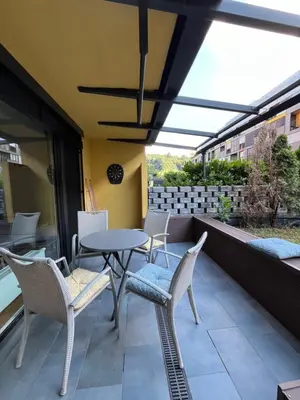 a patio with chairs and a table on a balcony at Oasis Atrium Apartment with free parking in Ljubljana